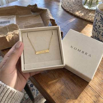 Collar dorado personalizado con el nombre Camila en su caja NOMBRA